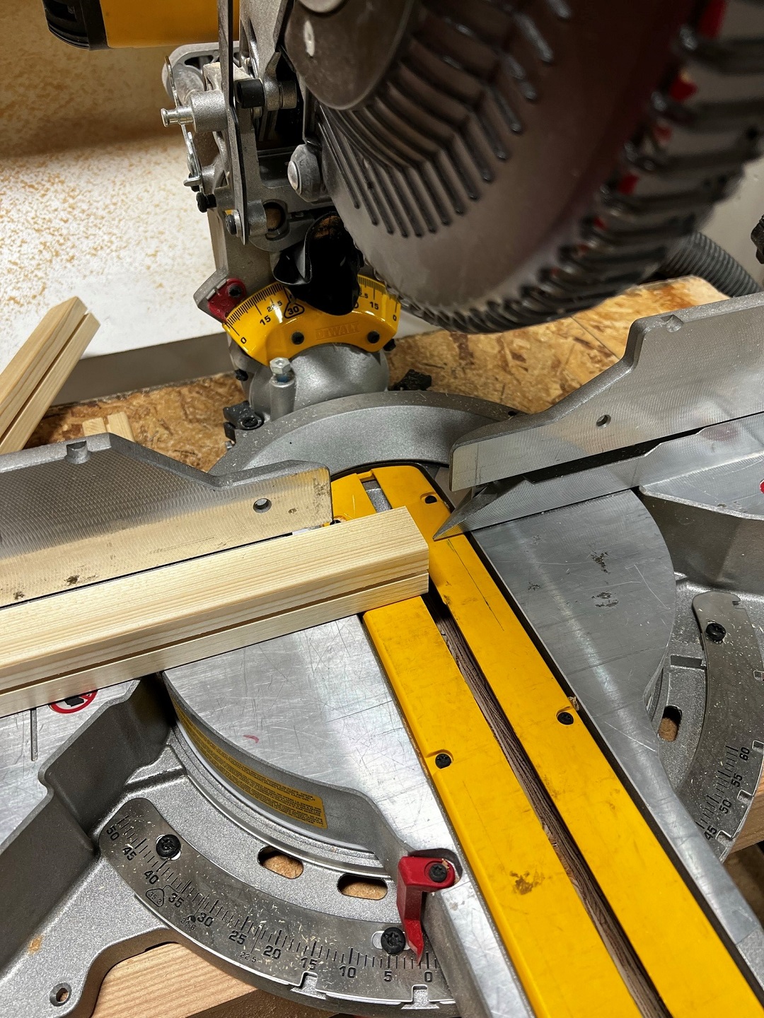 Table saw cutting wooden frame to size