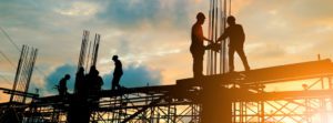 Silhouette of engineer and construction team working at site over blurred background sunset pastel for industry background with Light fair.