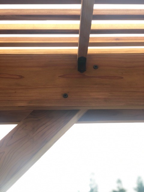 Outdoor Accents® structural wood screws fastening diagonal tops to the girders.