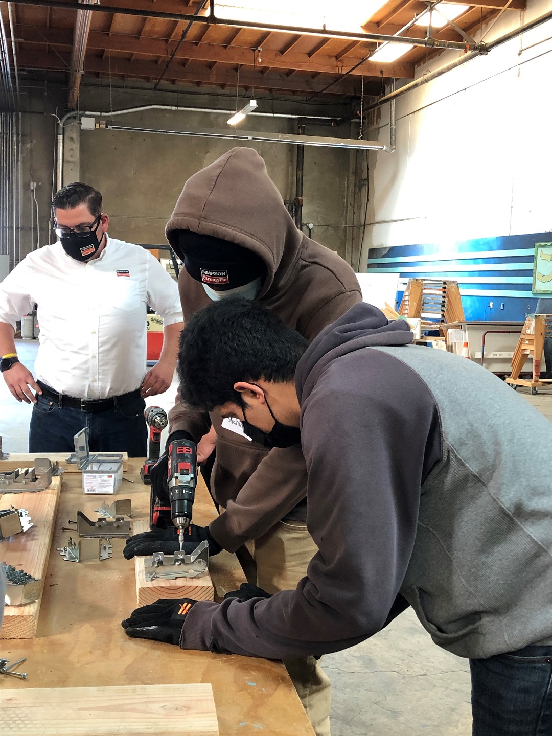 Students getting hands on drilling a Simpson Strong-Tie connector