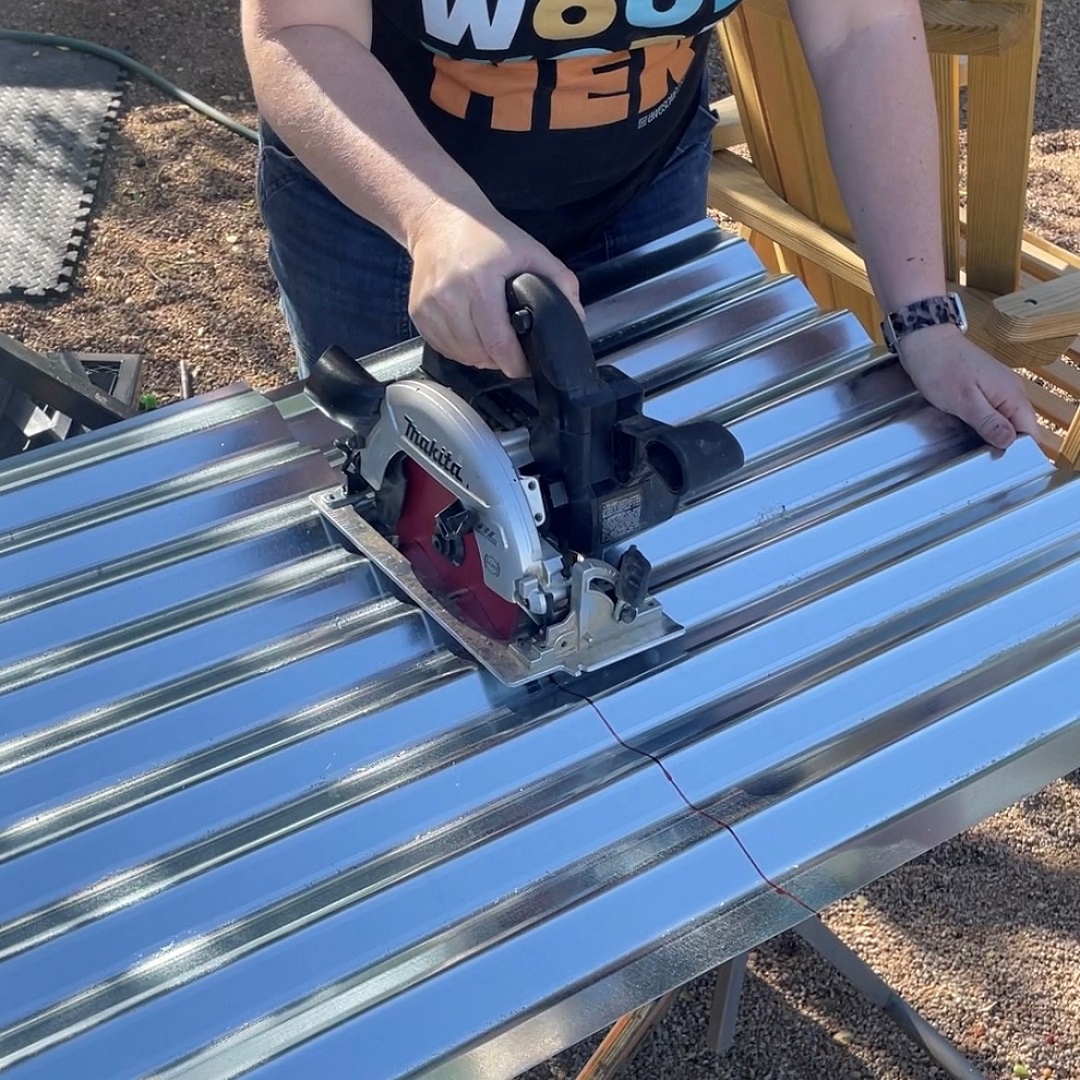 Cutting the corrugated metal roof for the firewood rack