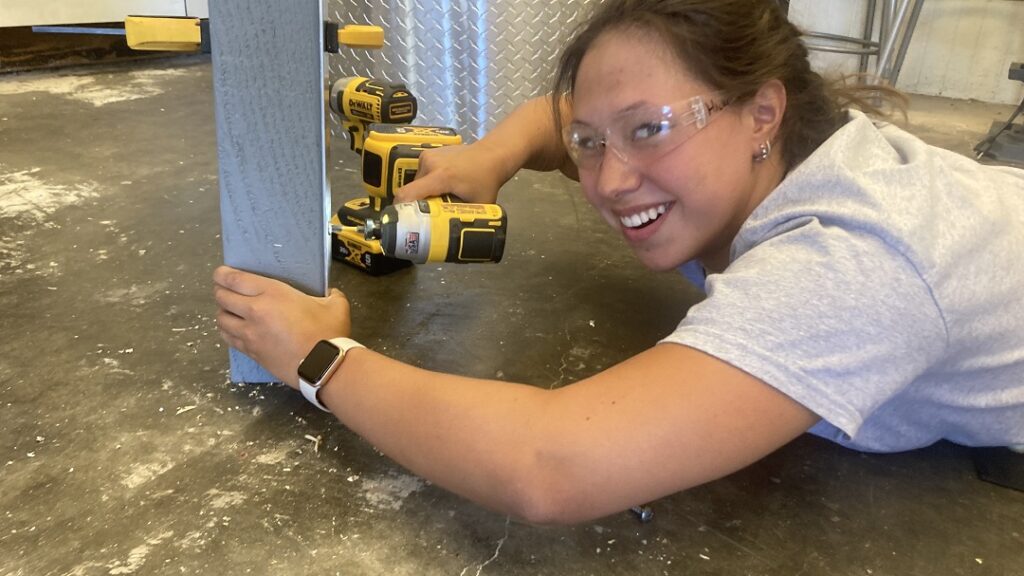 Katie Hickey working on the aluminum framing of the rest station