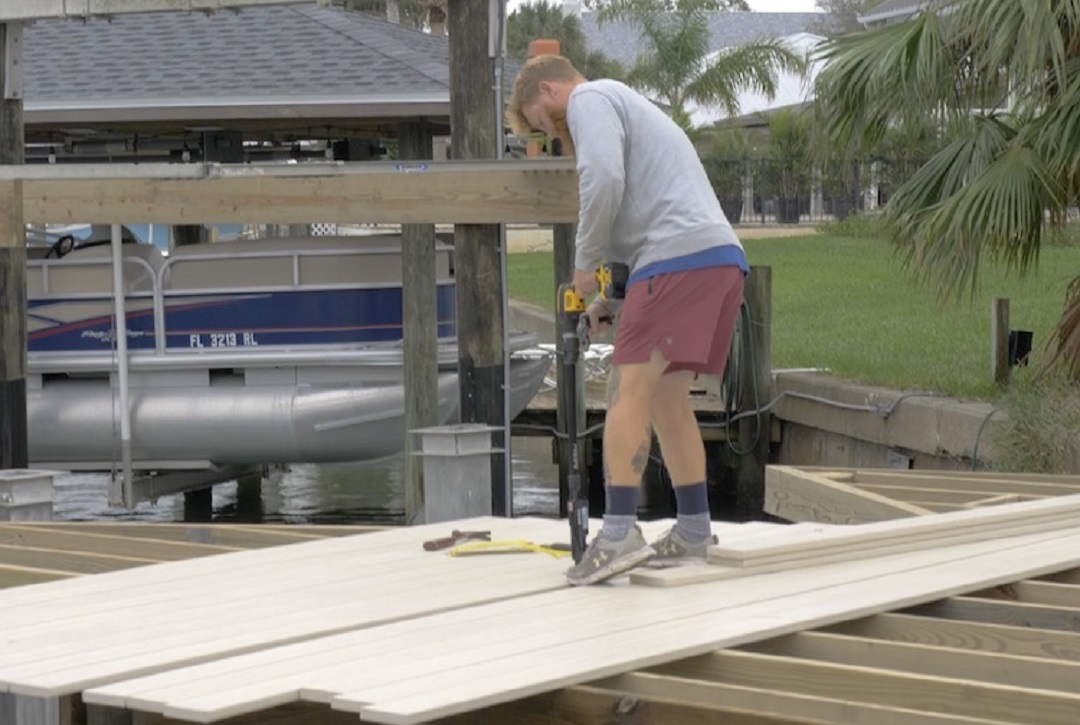 Laying the new board with Simpson Strong-Tie Quik Drive® Cordless PRO300SG2 Decking System   