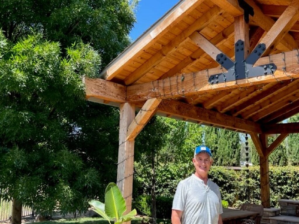 Brian Magstadt posing alongside his pavilion.