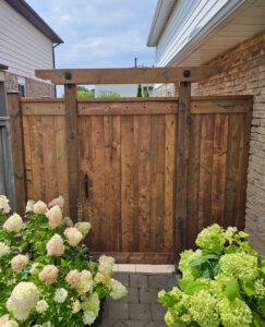 Fence and gate surrounded by lush garden