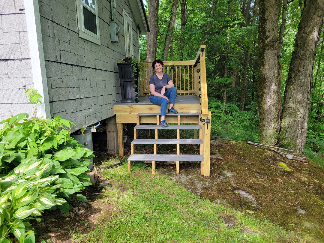 Lacy sitting on the steps of her new deck