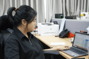 Nghi Chau at their desk