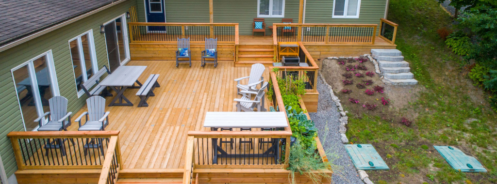 Pictured above is a wooden deck attached to a two-story house.