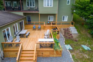 Pictured above is a wooden deck attached to a two-story house.