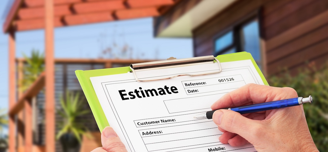 Hand writing an estimate on a clipboard for Home Building Renovation