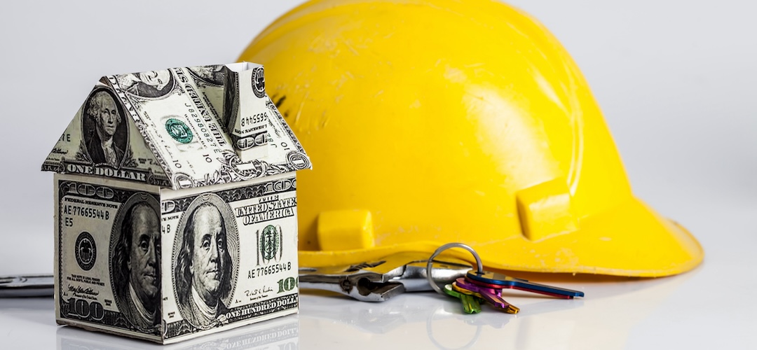 construction bid, a yellow helmet and a house made of 100 dollar bills